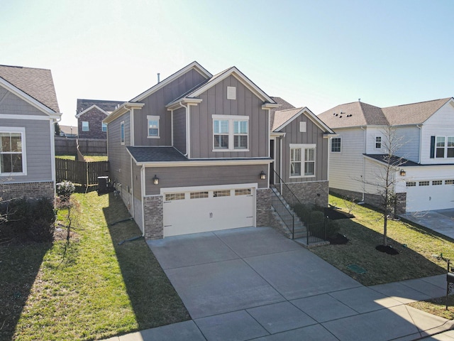 craftsman inspired home featuring driveway, an attached garage, fence, board and batten siding, and a front yard