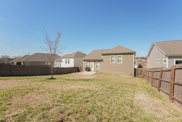 back of house with a patio, a lawn, a fenced backyard, and a residential view