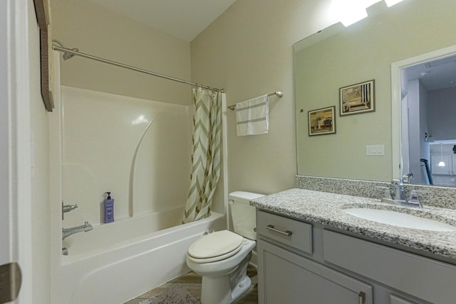 bathroom featuring toilet, shower / bath combo with shower curtain, and vanity