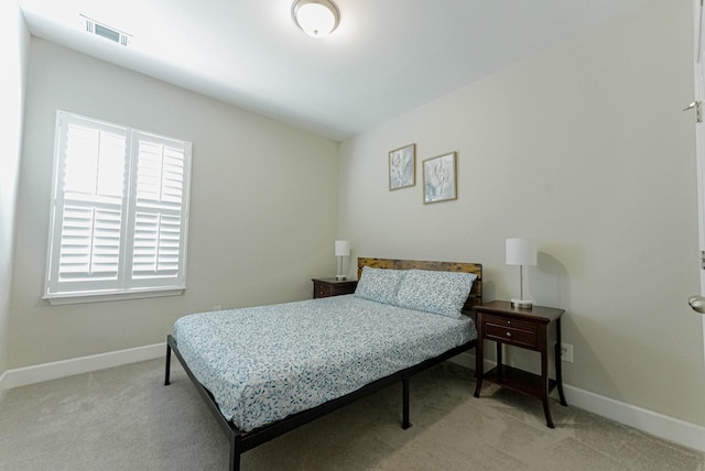 carpeted bedroom with visible vents and baseboards