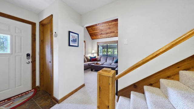 foyer with wooden ceiling, baseboards, stairway, and vaulted ceiling