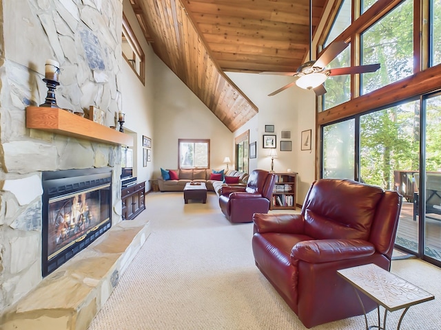 living room featuring ceiling fan, wooden ceiling, carpet floors, a fireplace, and a towering ceiling