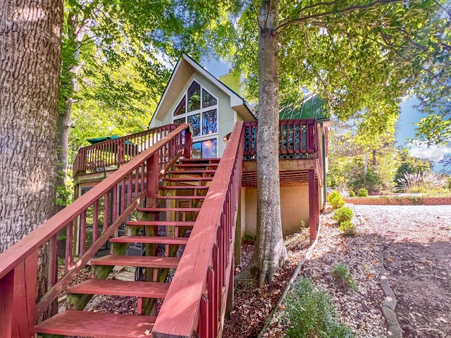 view of play area featuring stairs and a deck