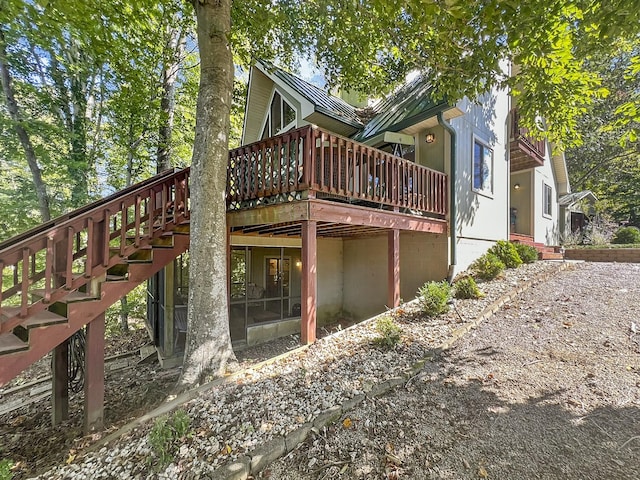 back of house featuring a wooden deck