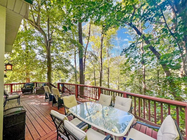 wooden terrace featuring outdoor dining area