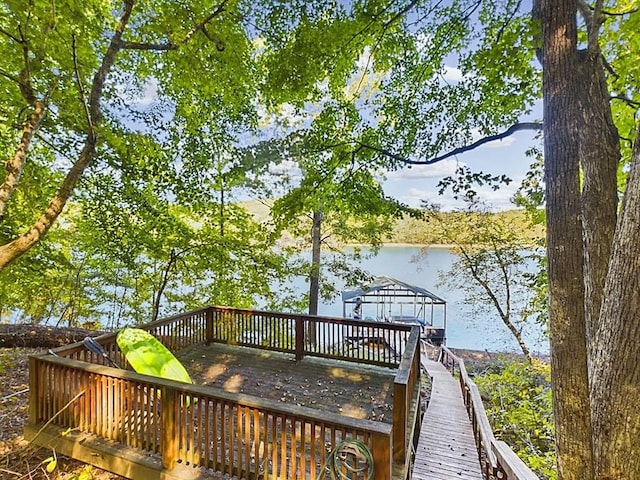 wooden terrace featuring a water view and a boat dock