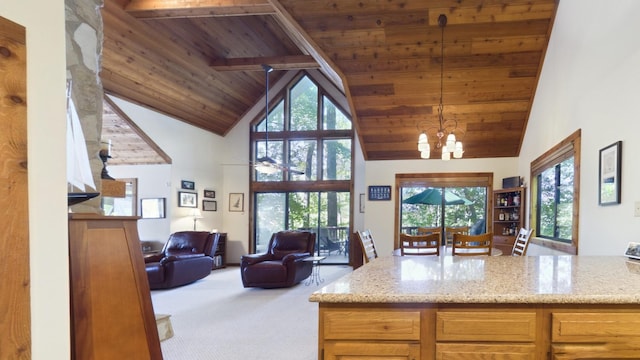 kitchen with a chandelier, wood ceiling, open floor plan, carpet flooring, and high vaulted ceiling