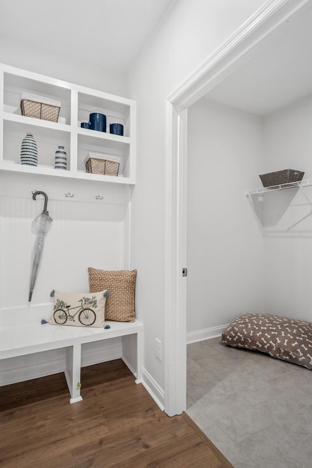 mudroom with wood finished floors and baseboards