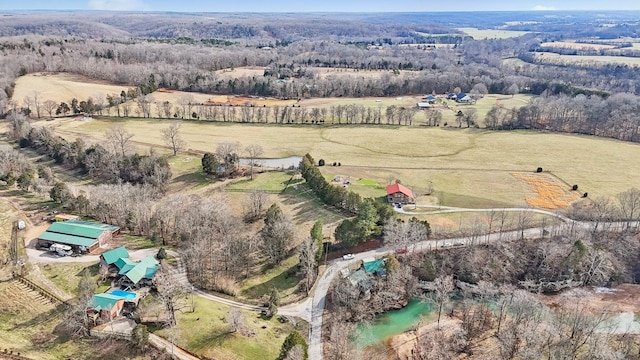 birds eye view of property featuring a wooded view and a rural view