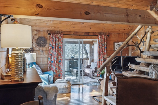 living room featuring hardwood / wood-style floors and wooden walls