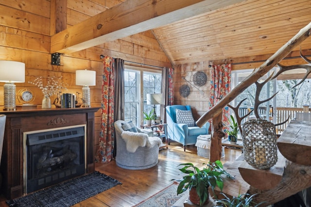 living area with a fireplace, wood-type flooring, vaulted ceiling, wooden walls, and wooden ceiling