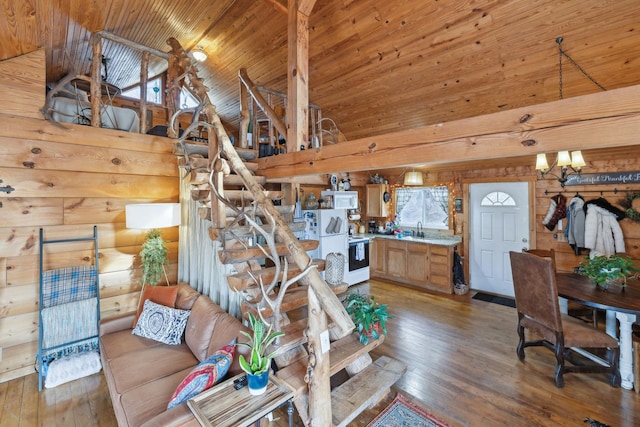 living room with wooden ceiling, high vaulted ceiling, light wood-style floors, and an inviting chandelier