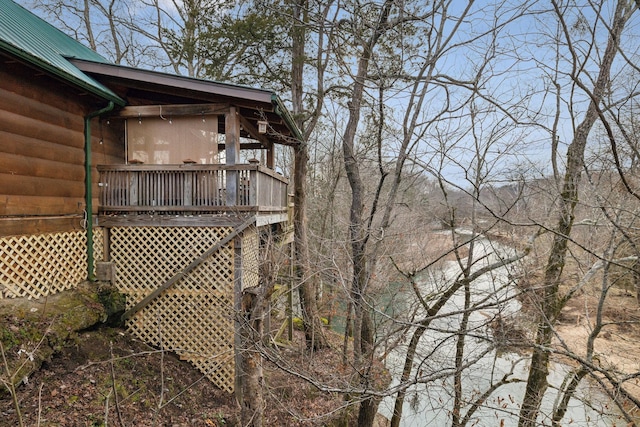 view of home's exterior featuring metal roof and log veneer siding