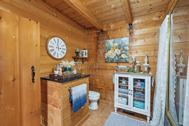 full bath featuring beam ceiling, toilet, wood ceiling, wooden walls, and tile patterned floors