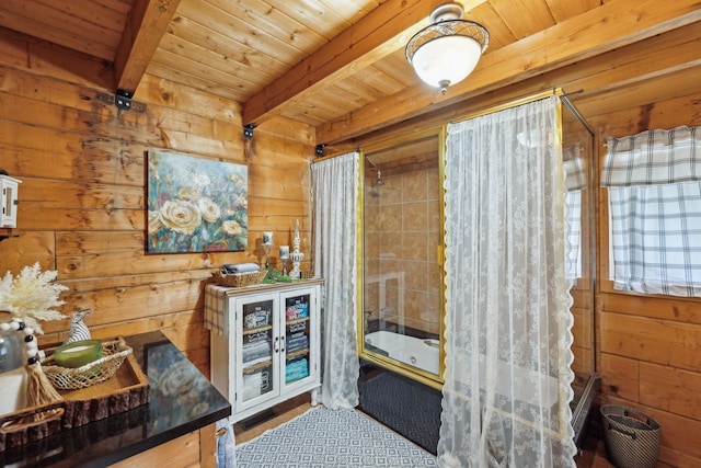 interior space with wood ceiling, shower / tub combo with curtain, wooden walls, and beamed ceiling