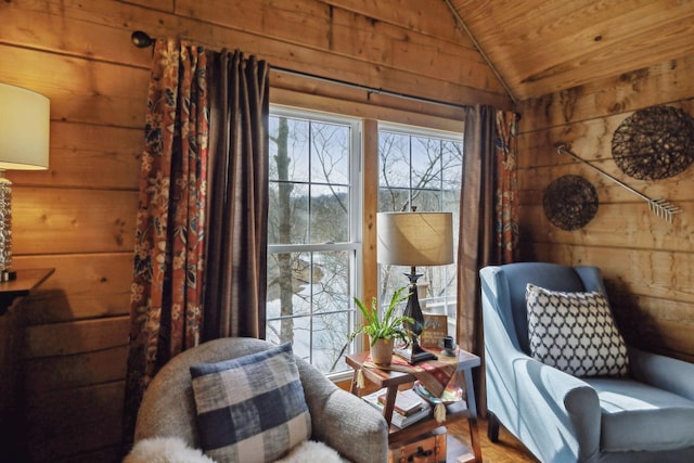 sitting room featuring lofted ceiling, wooden ceiling, and wooden walls