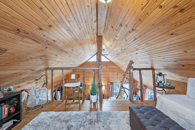 bedroom featuring multiple windows, vaulted ceiling, wooden walls, and hardwood / wood-style flooring