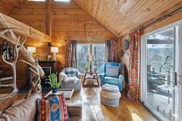 living area featuring lofted ceiling, wooden ceiling, and hardwood / wood-style flooring