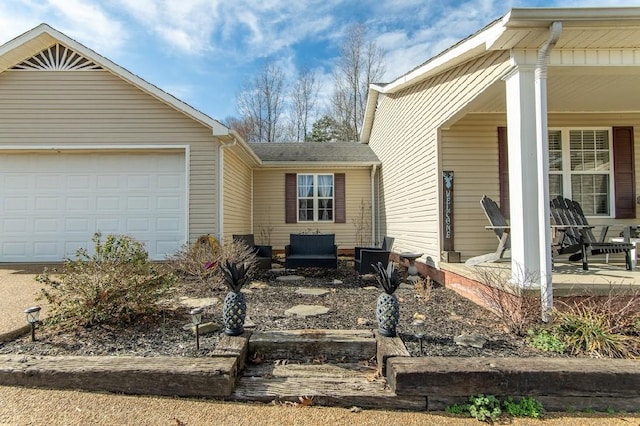 view of front of house featuring an attached garage and a porch