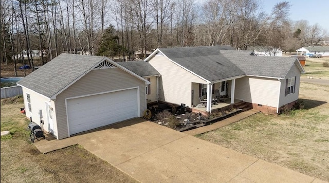 ranch-style home with covered porch, roof with shingles, crawl space, and a detached garage