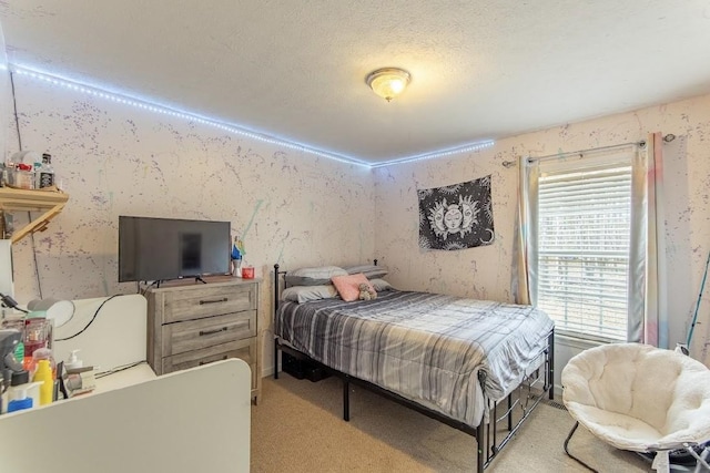 bedroom featuring a textured ceiling, light colored carpet, and wallpapered walls