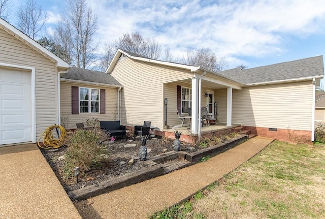 exterior space with a garage, a yard, a shingled roof, and crawl space