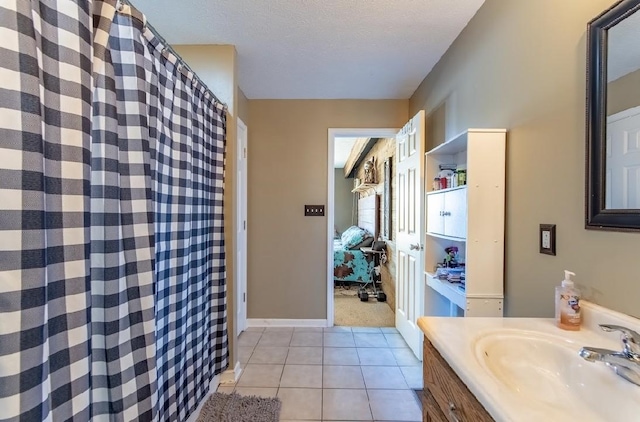 bathroom with baseboards, a shower with curtain, tile patterned floors, a textured ceiling, and vanity