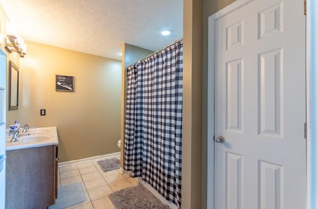 bathroom with a shower with shower curtain, toilet, tile patterned floors, a textured ceiling, and vanity