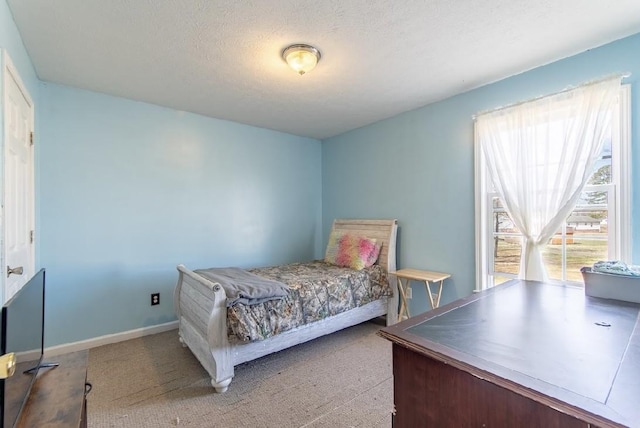 bedroom featuring a textured ceiling and baseboards