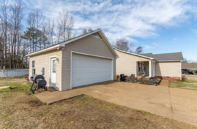 view of front of property featuring a garage, crawl space, and an outdoor structure