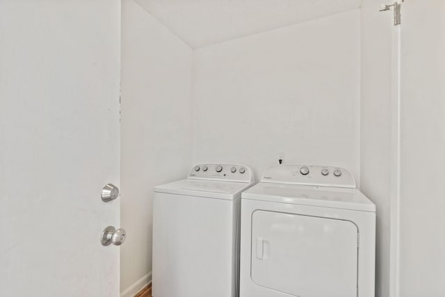 clothes washing area featuring laundry area and washing machine and clothes dryer