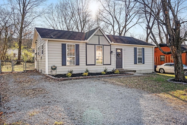 view of front of property with crawl space, fence, and gravel driveway