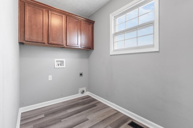 laundry room featuring washer hookup, cabinet space, electric dryer hookup, and baseboards