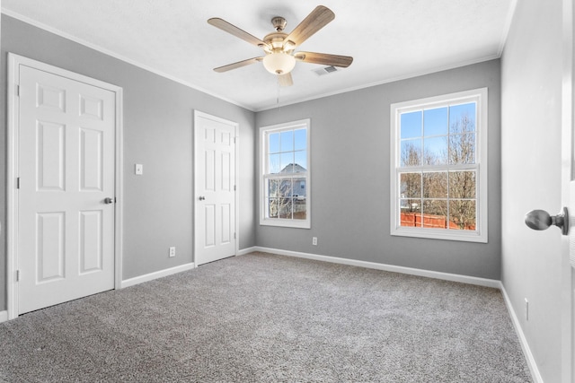 unfurnished bedroom featuring ornamental molding, carpet, and baseboards