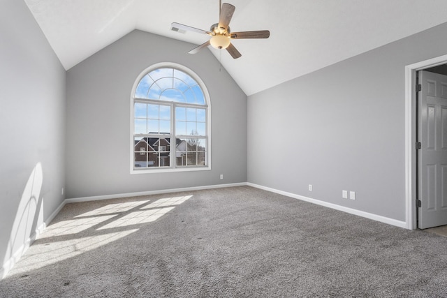 carpeted empty room with a ceiling fan, visible vents, vaulted ceiling, and baseboards