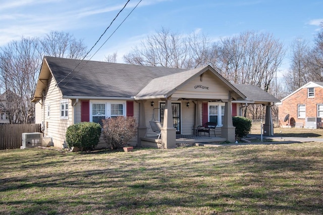 view of front of property with a shingled roof, central AC unit, a porch, fence, and a front lawn