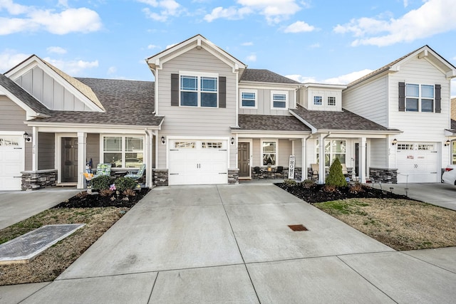 view of property featuring an attached garage, a shingled roof, a porch, and concrete driveway