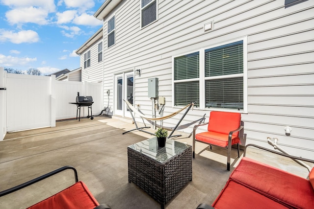 view of patio / terrace with a grill and fence