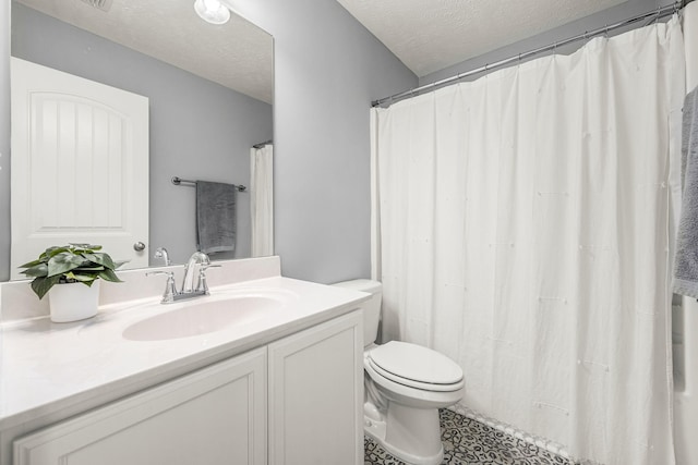 full bathroom featuring a textured ceiling, toilet, and vanity