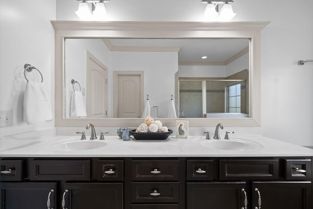 full bath with double vanity, a stall shower, and a sink