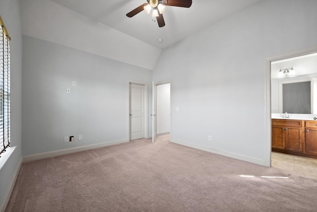 unfurnished bedroom featuring light carpet, baseboards, and a sink