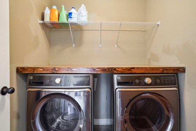 washroom featuring laundry area and separate washer and dryer