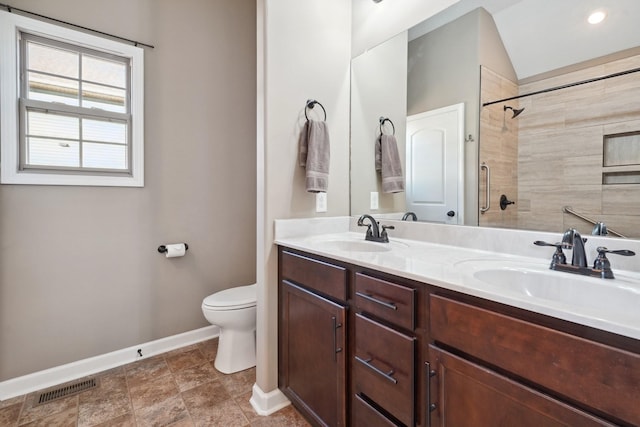 bathroom with toilet, a sink, visible vents, and a tile shower