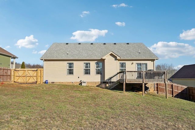 back of house featuring a deck, a fenced backyard, a shingled roof, a yard, and crawl space