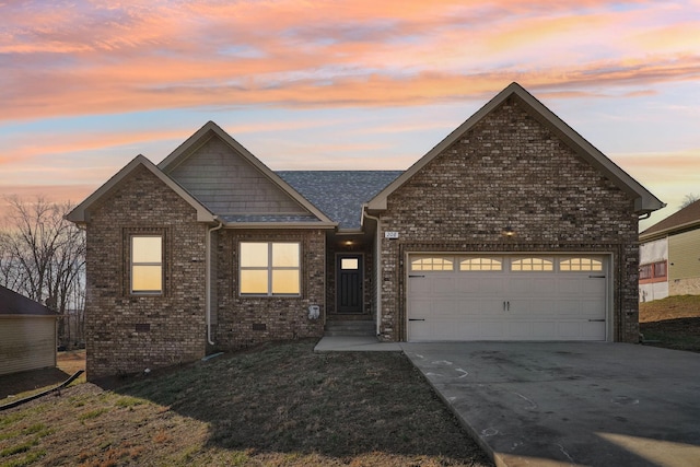 view of front facade featuring brick siding, a yard, crawl space, a garage, and driveway