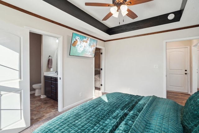 unfurnished bedroom with ensuite bathroom, a tray ceiling, ornamental molding, and baseboards