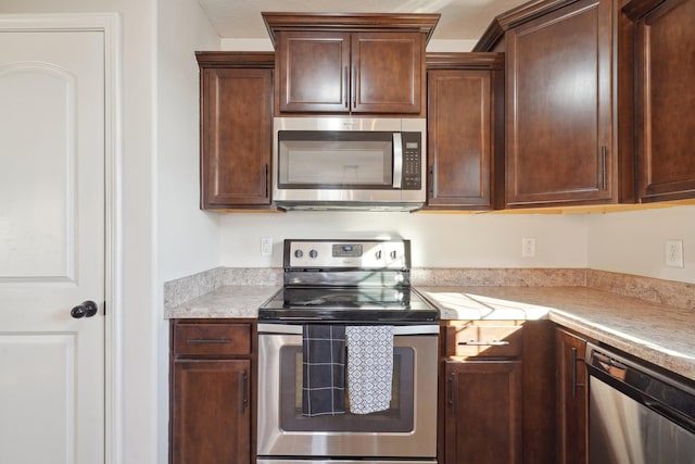 kitchen featuring appliances with stainless steel finishes and light countertops