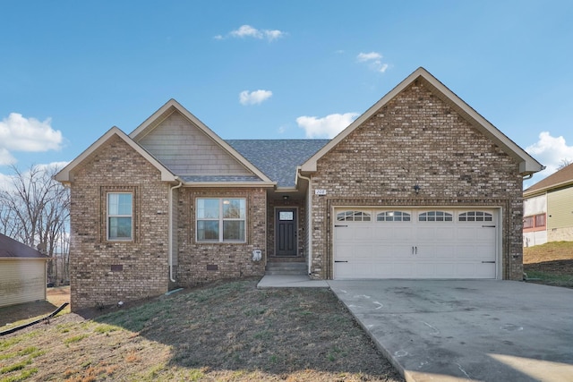 view of front of home with a shingled roof, concrete driveway, crawl space, an attached garage, and brick siding