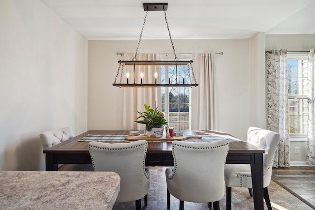 dining area featuring a notable chandelier and wood finished floors