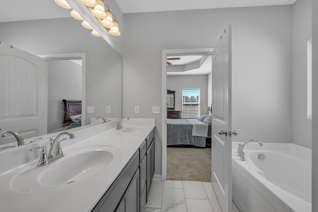 ensuite bathroom featuring double vanity, a garden tub, a sink, and ensuite bathroom